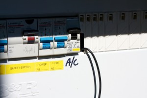 Clamp wire routed behind the fuse box close up